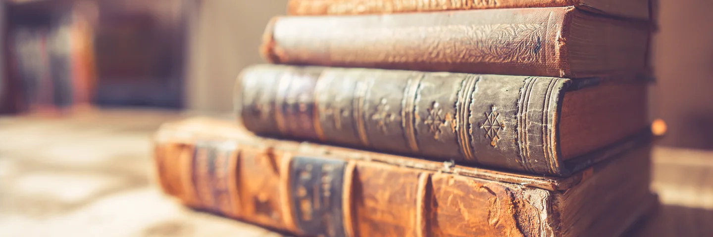 A stack of antique leather-bound books