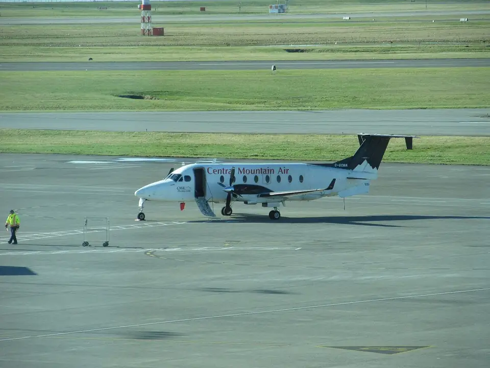 A turboprop aircraft on the tarmac at Vancouver International Airport